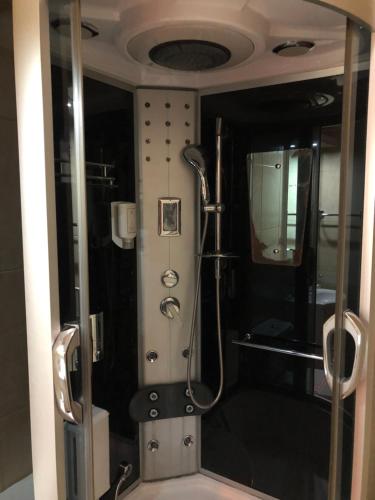 a shower in a bathroom with a glass door at Hotel Royal in Bijelo Polje
