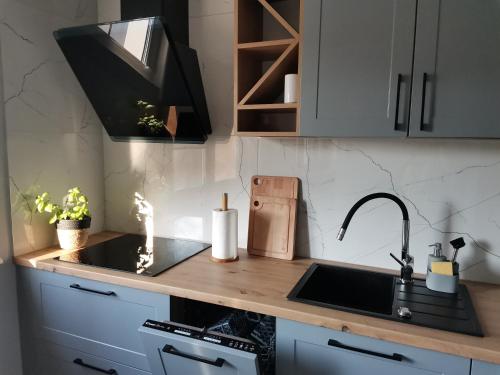 a kitchen with a sink and a counter top at Apartament z widokiem na Zamek in Malbork