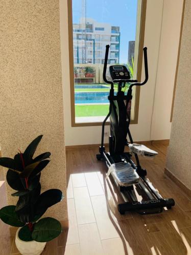 a room with a exercise machine on the floor at APPARTEMENT PARADISIAQUE entre HAMMAMET et NABEUL in Nabeul