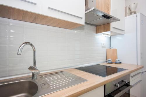 a kitchen with a sink and a counter top at Holiday Home Ivana in Brodarica