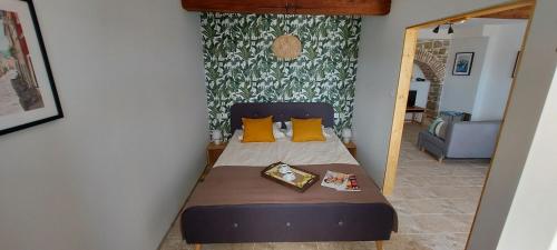 a small bedroom with a bed with yellow pillows at Apartment Motovun in Motovun