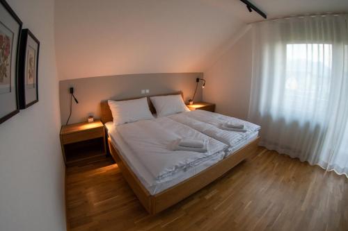 a bedroom with a large bed with two night stands at Hiša na Vrtu in Šenčur