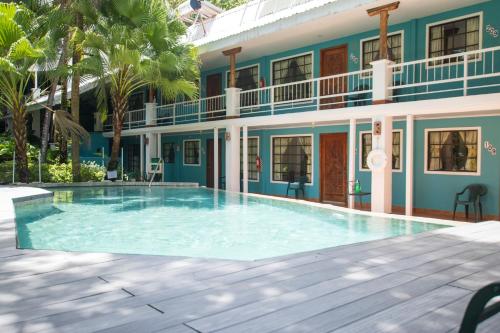 a swimming pool in front of a house at Oceanfront Hotel Verde Mar direct access to the beach in Manuel Antonio