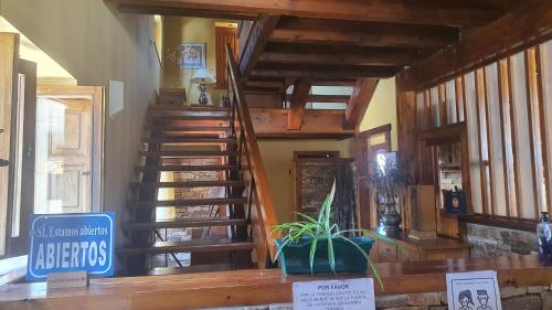 a staircase in a house with a sign in front of it at Posada de Serrada in Serrada de la Fuente