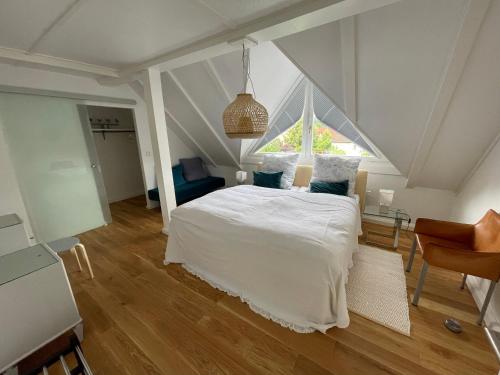 a bedroom with a white bed and a window at Gaensebluemchen 2 Apartment daisy 2 in Walsdorf