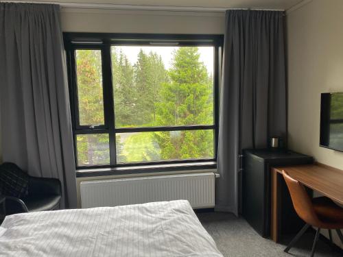 מיטה או מיטות בחדר ב-Blue Hotel Fagrilundur - On The Golden Circle