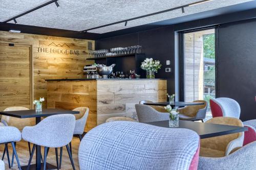 a restaurant with tables and chairs and a counter at Hotel Sant'Orso - Mountain Lodge & Spa in Cogne