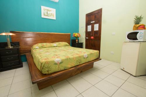 a bedroom with a bed and a small refrigerator at Oceanfront Hotel Verde Mar direct access to the beach in Manuel Antonio