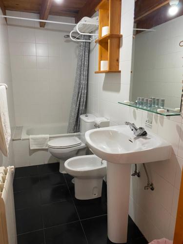 a bathroom with a sink and a toilet at Les Vegues II in Santillán