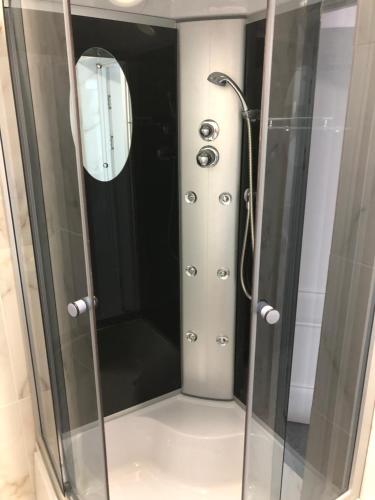 a shower with a glass door in a bathroom at PANORAMA BRIZ in Karolino-Buhaz