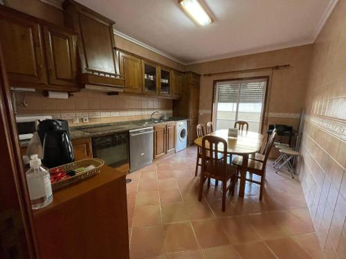 a kitchen with a table and chairs in it at Barra Sol - Lighthouse on the Beach in Praia da Barra