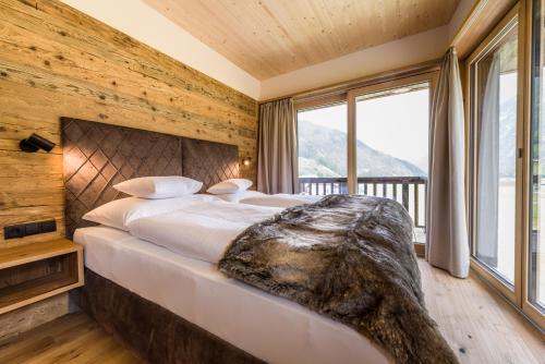 Posteľ alebo postele v izbe v ubytovaní NATURPARKGUT - alpdeluxe Apartments