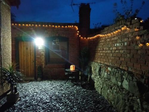 a building with a door with a light on it at THE OLD LAUNDRY, Prestatyn, North Wales - a unique little dog-friendly space, a 5 min walk to beach & town! in Prestatyn