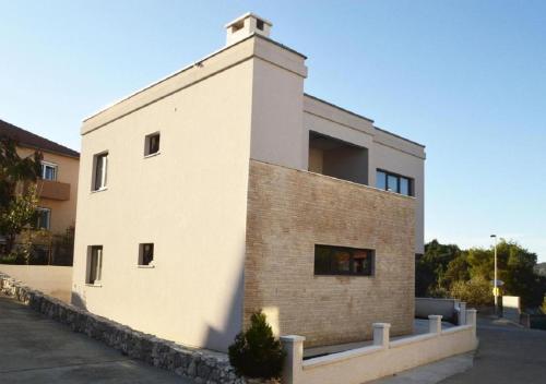 a white building with a brick wall at Island Residence in Sali
