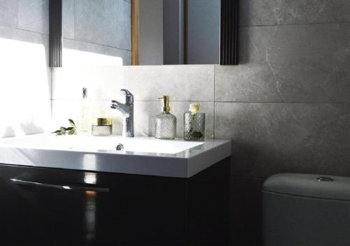 a bathroom with a sink and a toilet at Island Residence in Sali