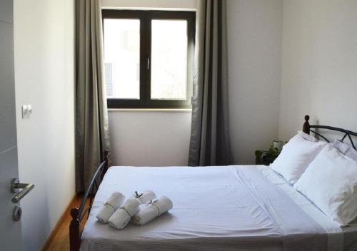 a bedroom with a white bed with two pillows on it at Island Residence in Sali
