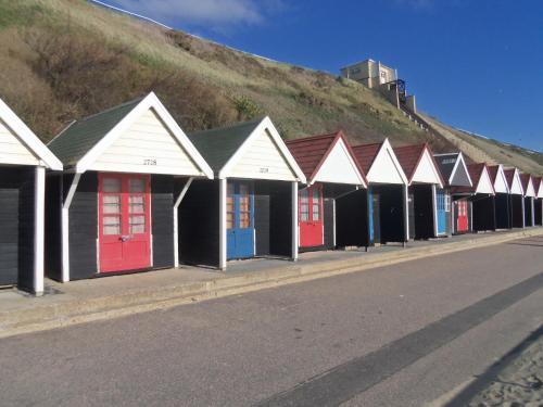 a row of beach huts on the side of a road at Alexander Lodge in Bournemouth