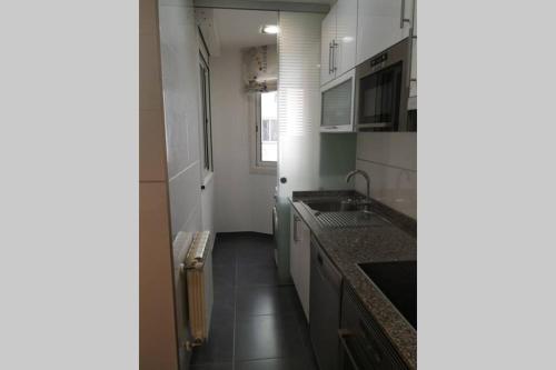 a kitchen with a sink and a counter top at La casa del centro in A Coruña