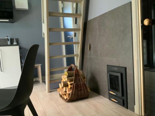 a fireplace in a kitchen with a basket next to it at Putnu pirts in Saulkrasti
