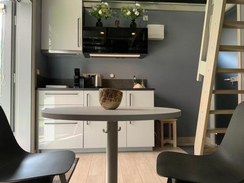 a small kitchen with a table and two chairs at Putnu pirts in Saulkrasti