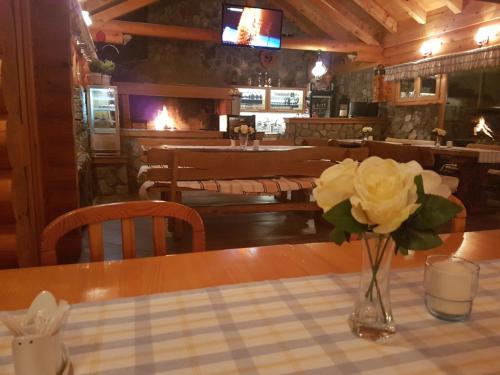 a vase of flowers on a table in a restaurant at Room in Rakovica with WiFi 4958-5 in Rakovica