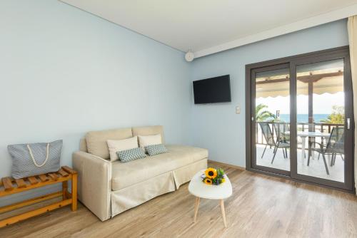 a living room with a couch and a table at Regos Resort Hotel in Neos Marmaras