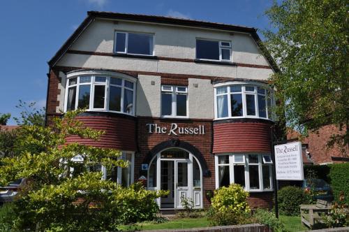 a brick building with a sign that reads the rustisk at The Russell in Scarborough