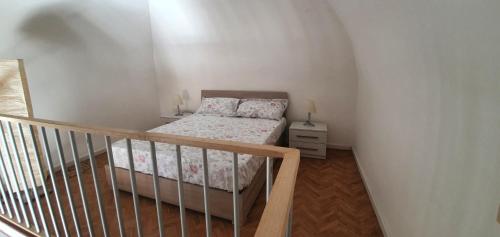 a small bedroom with a bed and a staircase at La casa nel barocco in Lecce