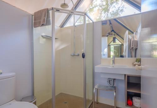 a bathroom with a shower and a sink at Emma Gorge Resort at El Questro in Kununurra