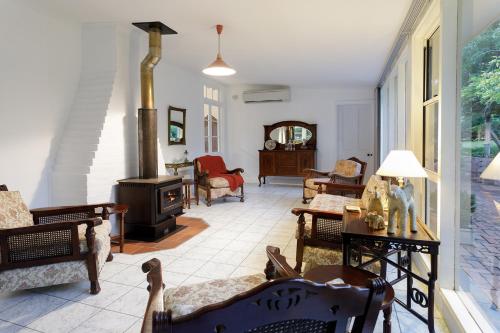 a living room with a wood stove in it at Ivanhoe Park Homestead in Tamworth