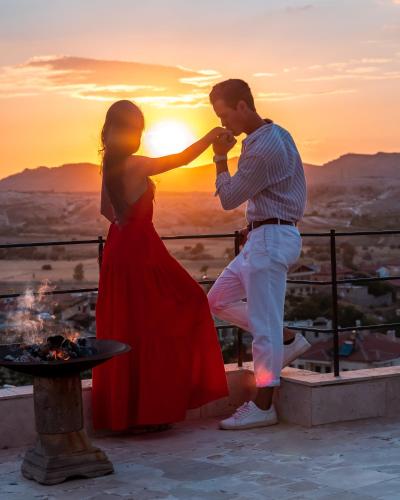 a man and a woman in front of the sunset at Seki Cave Suites in Goreme