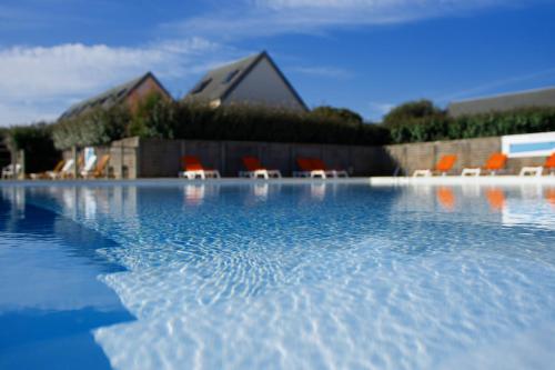 a group of chairs sitting on a pool of water at VVF Les Plages de Guérande La Turballe in La Turballe