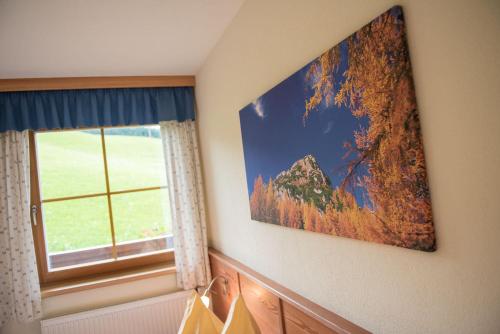 a picture hanging on a wall next to a window at Hinteregghof in Forstau