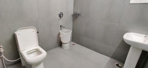 a bathroom with a toilet and a sink at Garden House in Mysore