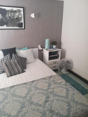 a bedroom with a bed and a night stand at La Vannière in Le Poujol-sur-Orb