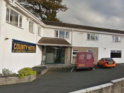 a building with a car parked in front of it at County Hotel in Helensburgh