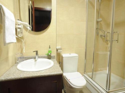 a bathroom with a toilet and a sink and a shower at Hotel Vukov Most in Nikšić