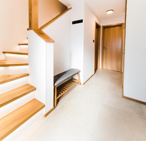 a hallway with stairs and a bench in a house at Garden 13 in Tolmin