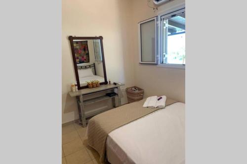 a bedroom with a bed and a mirror at Messinia view house in Akhladhokhórion