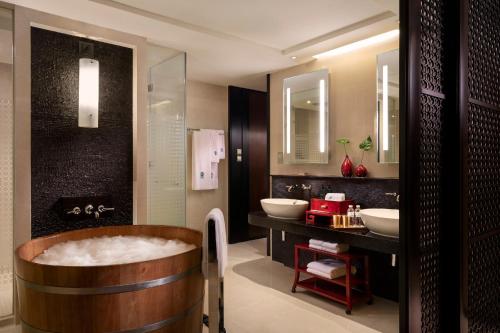 a bathroom with two sinks and a bath tub at Banyan Tree Macau in Macau