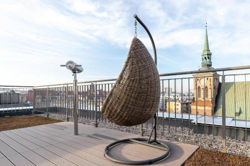 a basket sitting on top of a balcony at Garden Gates Apartments by Renters in Gdańsk