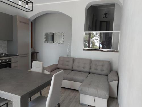 a living room with a table and a couch at Georgia in Porto Pino