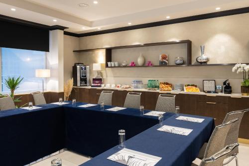 a dining room with blue tables and chairs at Best Western Plus Hôtel Massena Nice in Nice