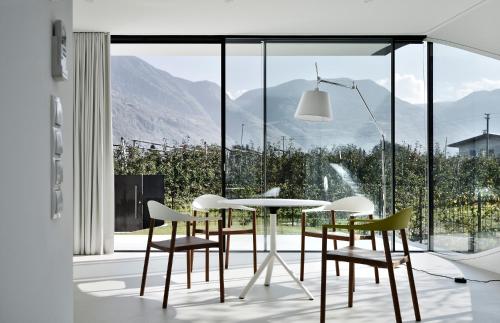 a dining room with a table and chairs at Mirror Houses in Bolzano