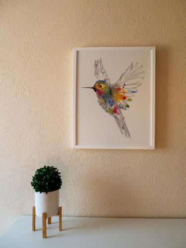 a painting of a hummingbird hanging on a wall at Załakowo Na Gwizdówce 13 całoroczny domek na Kaszubach in Załakowo
