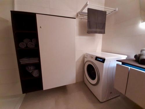 a small kitchen with a washing machine in it at Diamond Bled in Bled