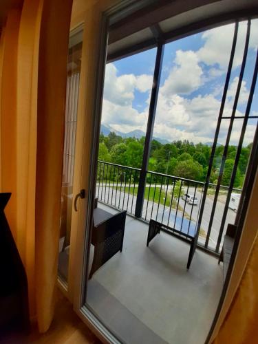 a view from a window of a balcony with a bench at Diamond Bled in Bled