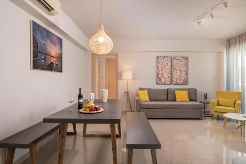 a living room with a couch and a table at Trianon Luxury Apartments & Suites in Chania Town