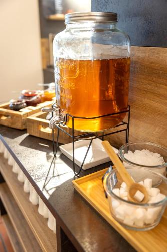 a jar of beer sitting on a counter with ingredients at JUFA Hotel Judenburg - Self Check-In in Judenburg