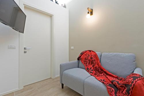 a red blanket sitting on a couch in a living room at Residence Armony in Misano Adriatico